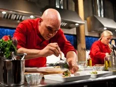 Iron Chef Cat Cora and Iron Chef Michael Symon working on their appetizers as seen on Food Networks, Chopped All Stars Tournament, Season 10 EP10-09
