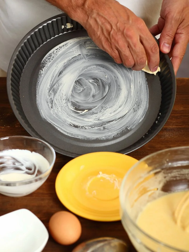 Making Sour Cream Lemon Cake. Preparing Cake Pans For Baking. Greasing with margarine or butter.