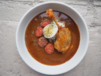 Housed in an old cotton mill in New Orleans' Warehouse District, Sac-a-lait is a neighborhood restaurant designed and built completely by the chefs and their families. The menu is highly influenced by farming, hunting and fishing, with sections that reflect each. A menu staple is the rotating gumbo. The duck-based gumbo is made with confit duck leg, housemade hunter's sausage, file powder, a scoop of whipped duck egg potato salad and, finally, a boiled duck egg on top.