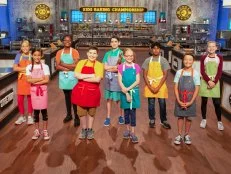 Hero shot of all bakers Brooke Waters, Taylor Pusha, Tarek Husseini, Dharma Sabapathy, Tori Church, Sophia Elrod, Trevin Alford, Sophie Tate, and Brady Stewart, as seen on Kids Baking Championship, Season 7.