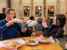 Hosts Bobby Flay and Sophie Flay take a photo and sample the Lobster Rolls at Red Hook Lobster Pound in Green Point Brooklyn, as seen on Flay vs Flay, Season 1.