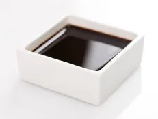 soy sauce in square bowl.