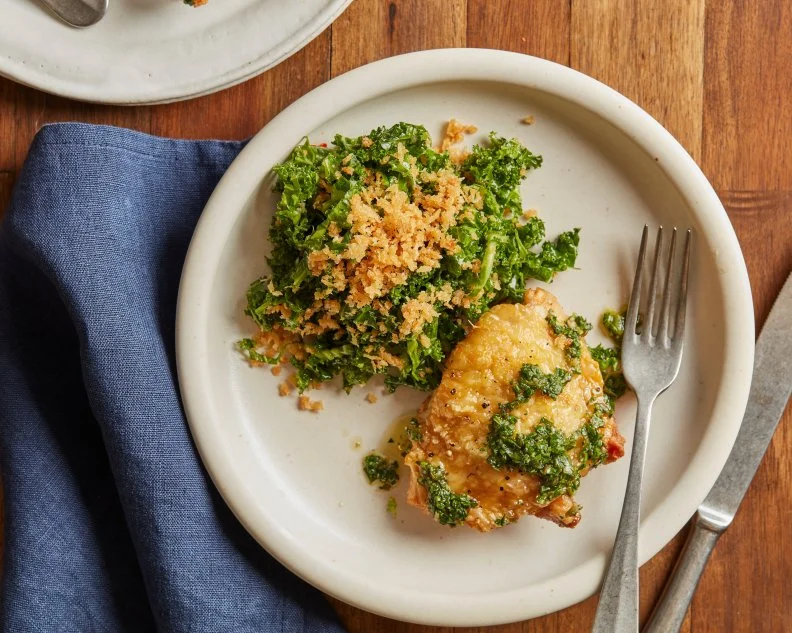 Description: Food Network Kitchen's Air Fryer Chicken Thighs with Salsa Verde and Lemony Kale Salad. Keywords: Lemon, Dijon Mustard, Red Pepper, Curly Kale, Panko, Pecorino Romano, Chicken Thighs, Capers, Garlic, Red Wine Vinegar, Parsley, Basil, Chives
