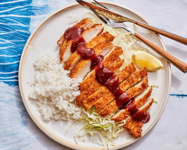 Description: Food Network Kitchen's Chicken Katsu. Keywords: Ketchup, Worcestershire Sauce, Soy Sauce, Eggs, Panko, Chicken Breasts, Cabbage, White Rice, Lemon