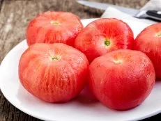 blanched tomatoes on white plate