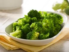 boiled broccoli in white bowl on table