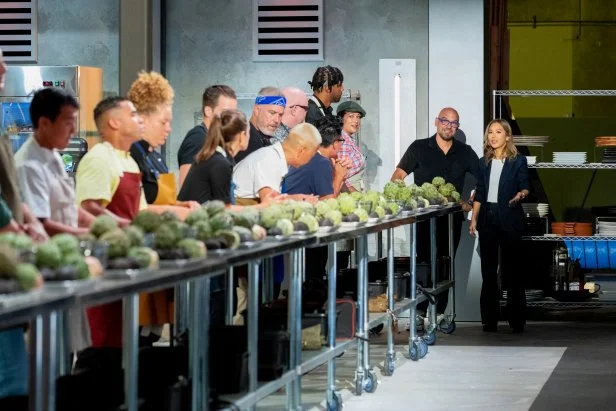 Contestants Matt Jordan, Daniel Lee, Marc Quinones, Charlie Ray, Mika Leon, Camille Le Caer, Chris Oh, Chad Rosenthal, Declan Horgan, Viet Pham, Christopher Ingram and Gabriella Baldwin prepare for the challenge presented by Hosts Michael Symon and Esther Choi, as seen on 24 in 24: Last Chef Standing, Season 1.
