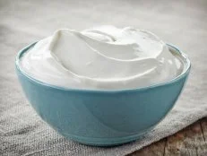 bowl of sour cream on linen napkin