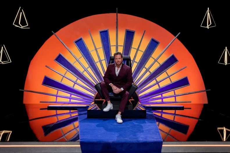 House of Knives host Scott Conant sitting on the cooking competition throne