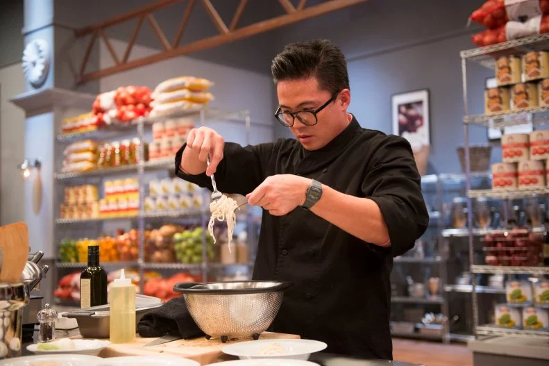 Viet Pham preparing a hot dog and beer broth ramen