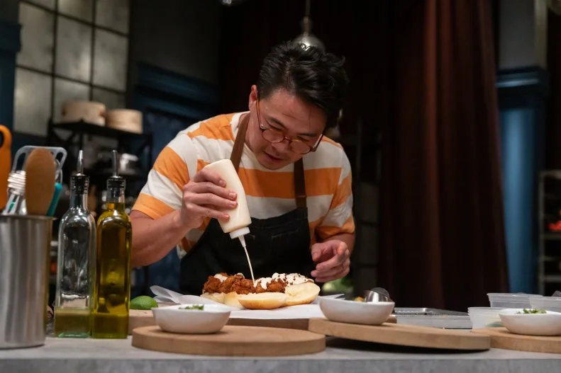 Viet Pham puts the finishing touches on a fried chicken sandwich