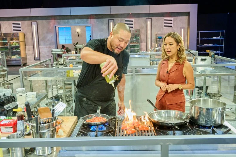 Contestant Kevin Lee talking with host Esther Choi while cooking challenge 18 Spicy Rice or Saftey, as seen on 24 in 24: Last Chef Standing, Season 2.