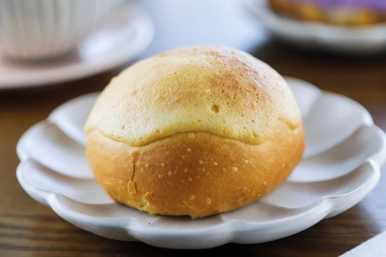 BBQ Pork Snow Bao as prepared by Chef/Owner Elaine Uykimpang Bentz at Cafe Mochiko in Cincinnati, Ohio, as seen on Food Network's Diners Drive-Ins and Dives, season 41.