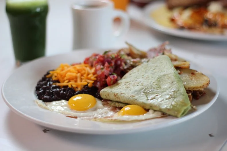 Pork Hash with Black Beans and Eggs from Succotash in Kansas City, Missouri, as seen on Food Network's Diners, Drive-Ins, and Dives.
