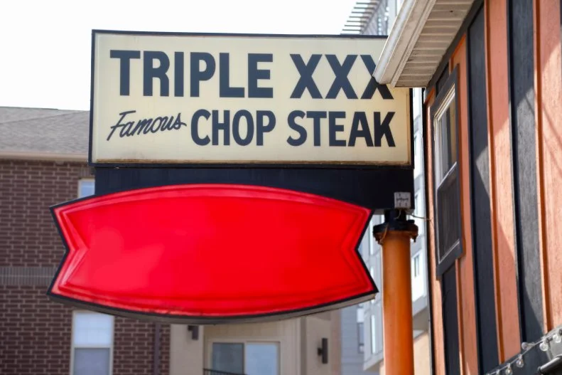 Exterior sign at Triple XXX Family Restaurant in West Lafayette, Indiana, as seen on Food Network's Triple D Nation, Season 7.