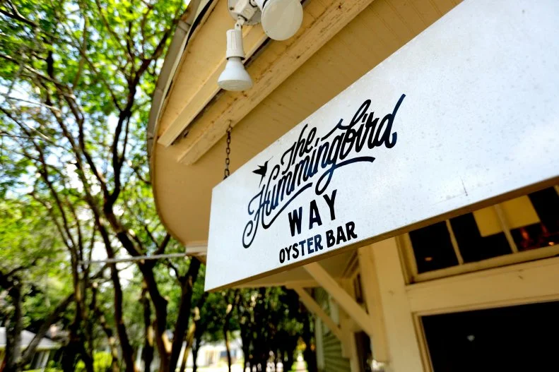 Signage of The Hummingbird Way Oyster Bar in Mobile, Alabama, as seen on Food Network's Diners Drive-Ins and Dives, season 38.