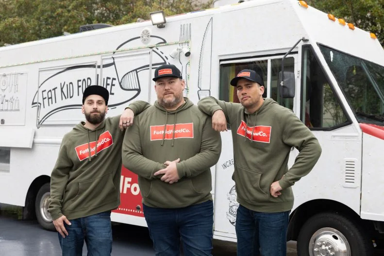Fat Kid Food Co team members in front of their food truck